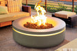 Modern round concrete gas fire pit with glowing LED accent and outdoor lounge seating.