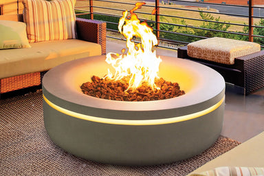 Modern round concrete gas fire pit with glowing LED accent and outdoor lounge seating.