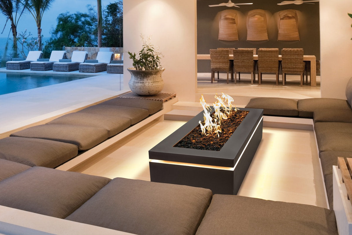 Halo 60 gas fire pit with LED lighting in a luxury outdoor lounge area.
