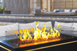 Halo 60 gas fire pit with glass wind guard and glowing flames close-up.