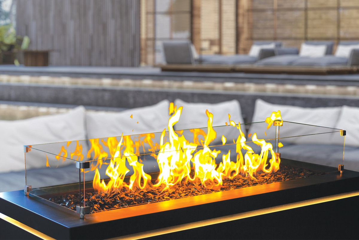 Halo 60 gas fire pit with glass wind guard and glowing flames close-up.