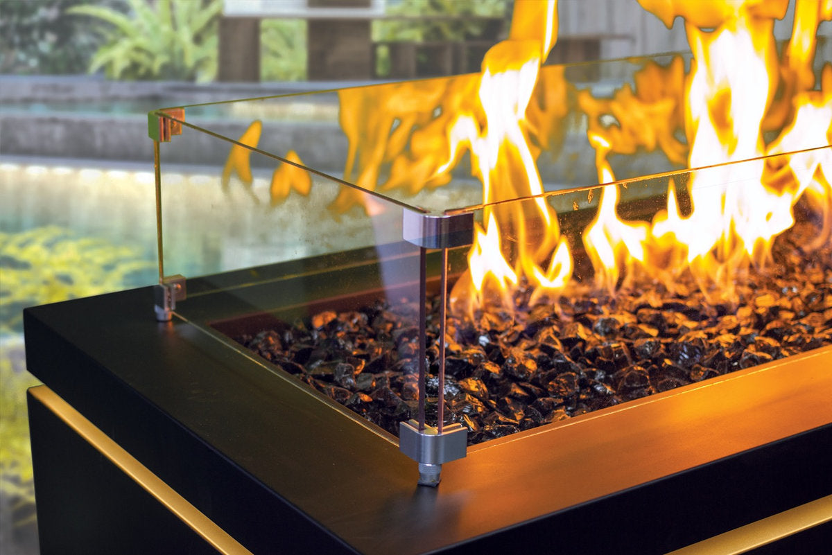 Close-up of Halo 60 gas fire pit with tempered glass surround and lava rocks.