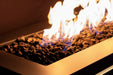 Close-up of Halo 60 gas fire pit flames burning over natural lava rocks.