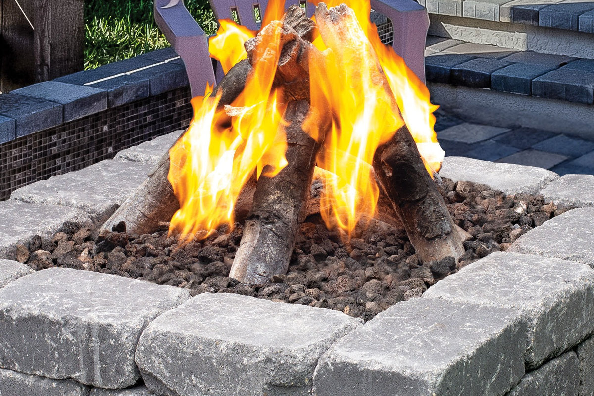 Close-up of Halo 44 gas fire pit with realistic log set and lava rocks.