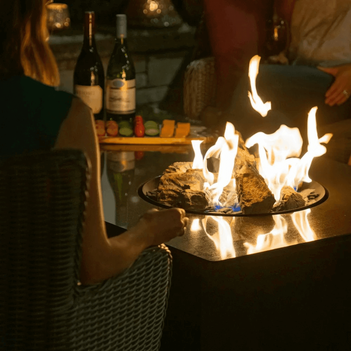 Jackson Grills Mountains West Fire Tall Table in use outdoors with active flames creating a warm gathering space.