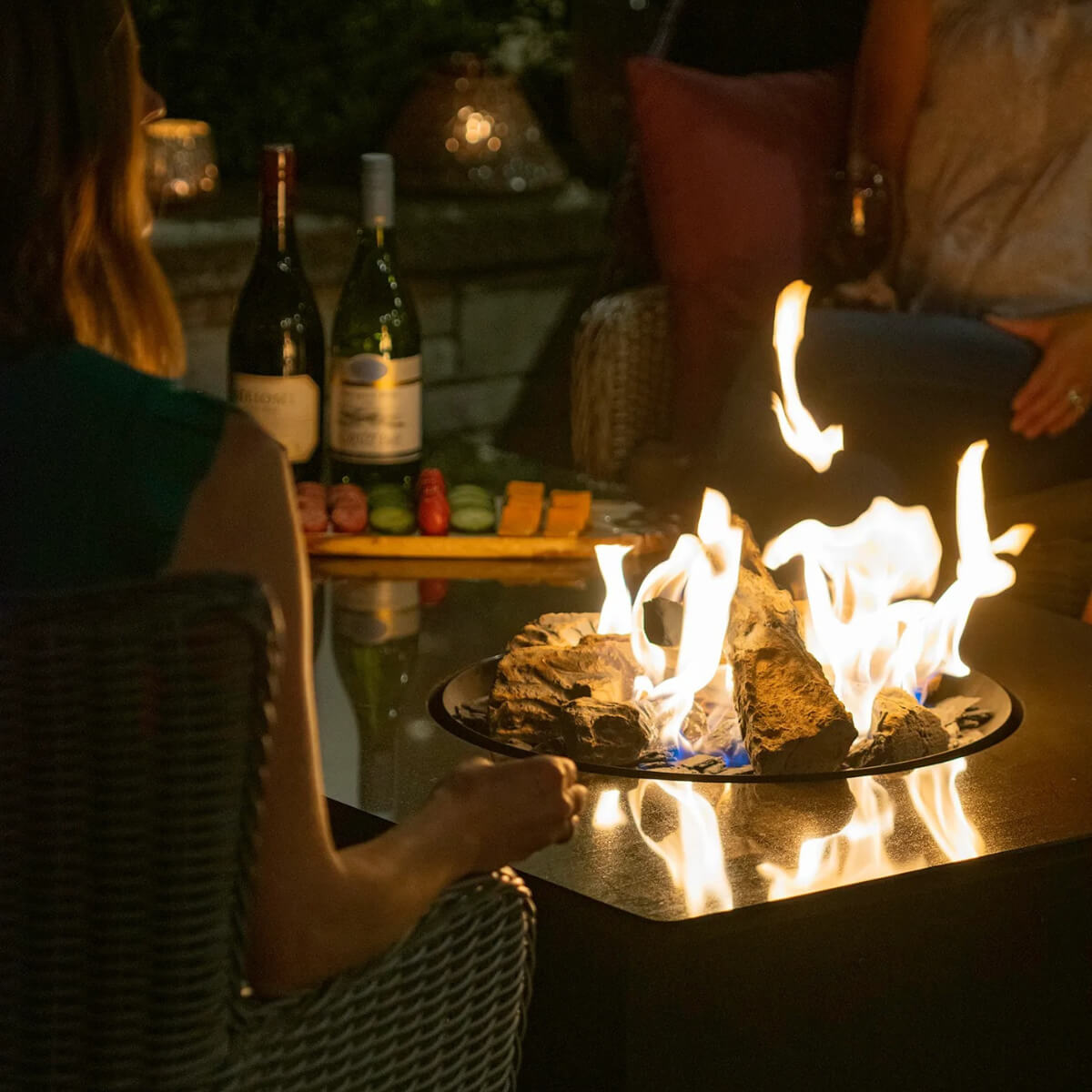 Jackson Grills Mountains West Fire Coffee Table in use outdoors with active flames creating a warm entertaining space.