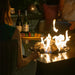 Jackson Grills Mountains West Fire Coffee Table in use outdoors with active flames creating a warm entertaining space.