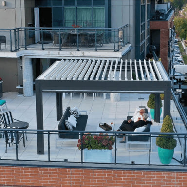 Rooftop terrace featuring a contemporary aluminum pergola with open louvered roof and lounge setup.