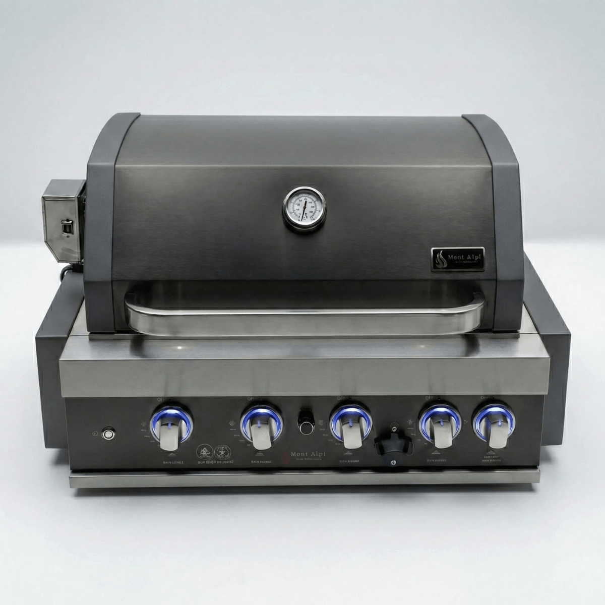 Front view of the Mont Alpi 32-Inch Black Stainless Steel Built-In Grill with closed hood, built-in temperature gauge, and blue LED illuminated control knobs.
