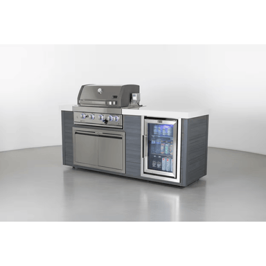 Studio display of the Mont Alpi 4-Burner Stainless Steel Art-wood Outdoor Island Grill with grey wood-effect panels, stainless steel grill, and integrated drinks refrigerator.