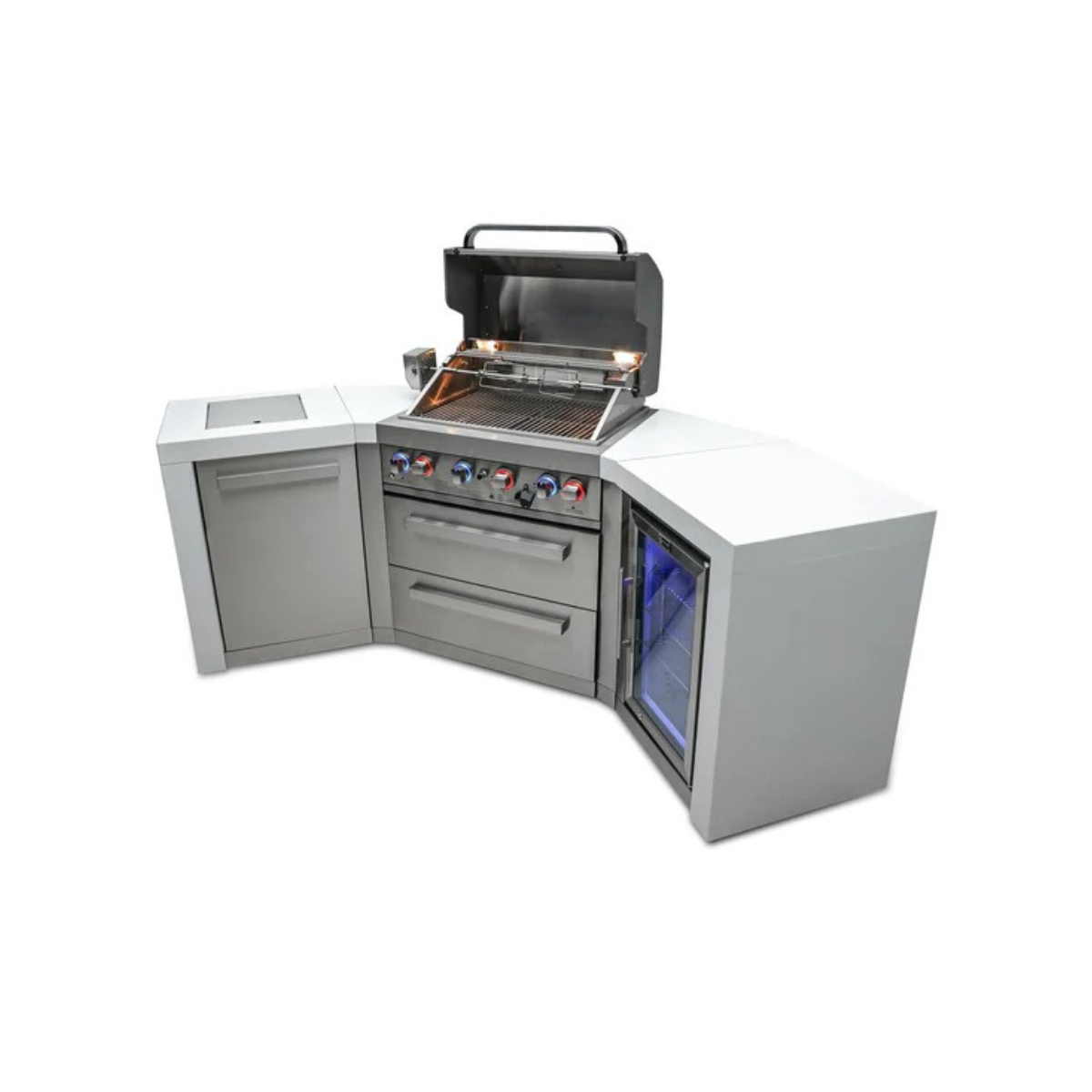Outdoor kitchen island with the grill hood open, showing the cooking grates, rotisserie system, illuminated control knobs, storage drawers, and built-in fridge.