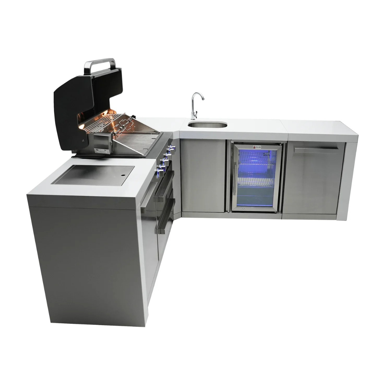 Side view of the outdoor kitchen island showing the open grill hood, illuminated beverage centre fridge, corner sink, and stainless steel cabinetry.
