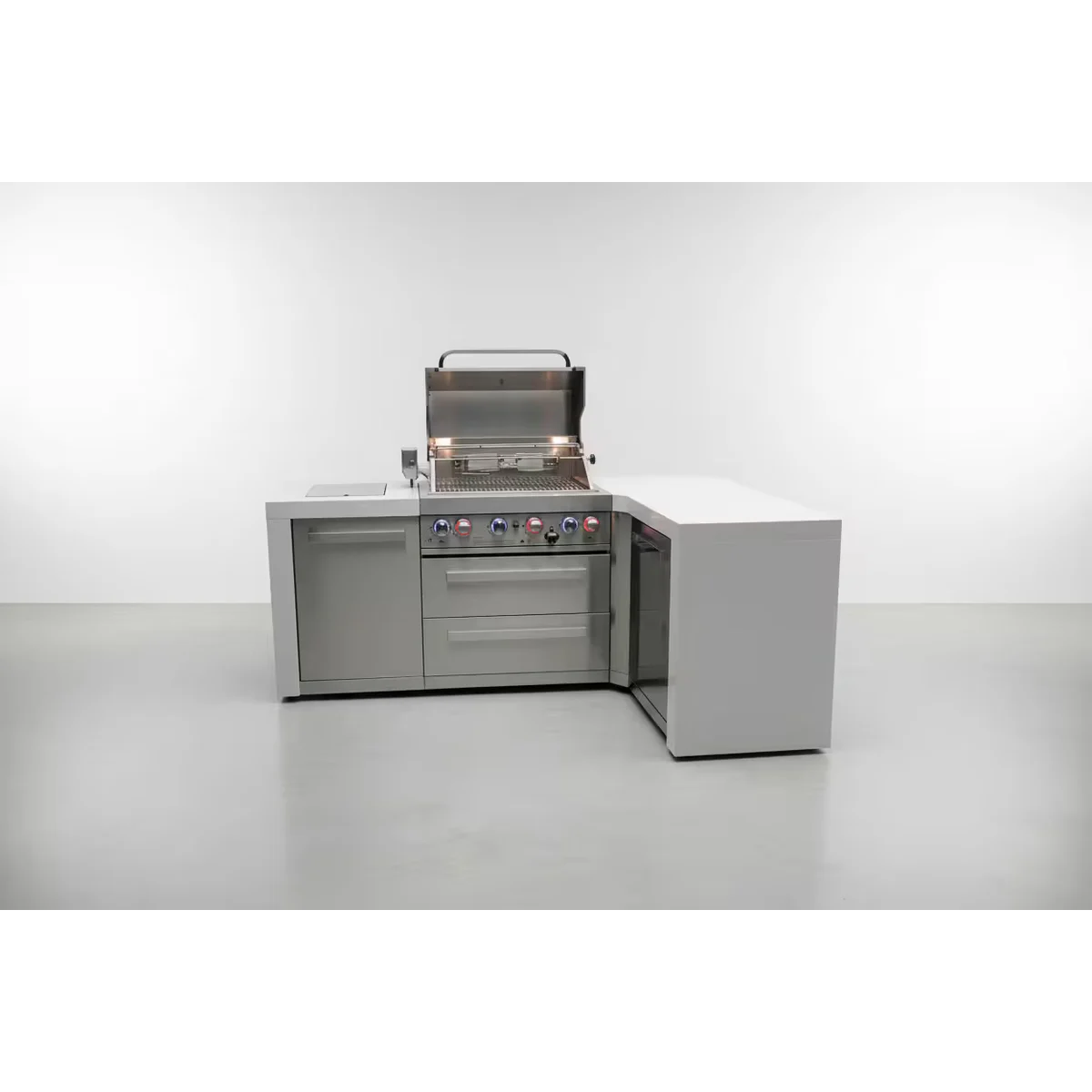 Front view of the outdoor kitchen island with the grill lid open, revealing the cooking area, illuminated control knobs, storage compartments, and corner cabinet.