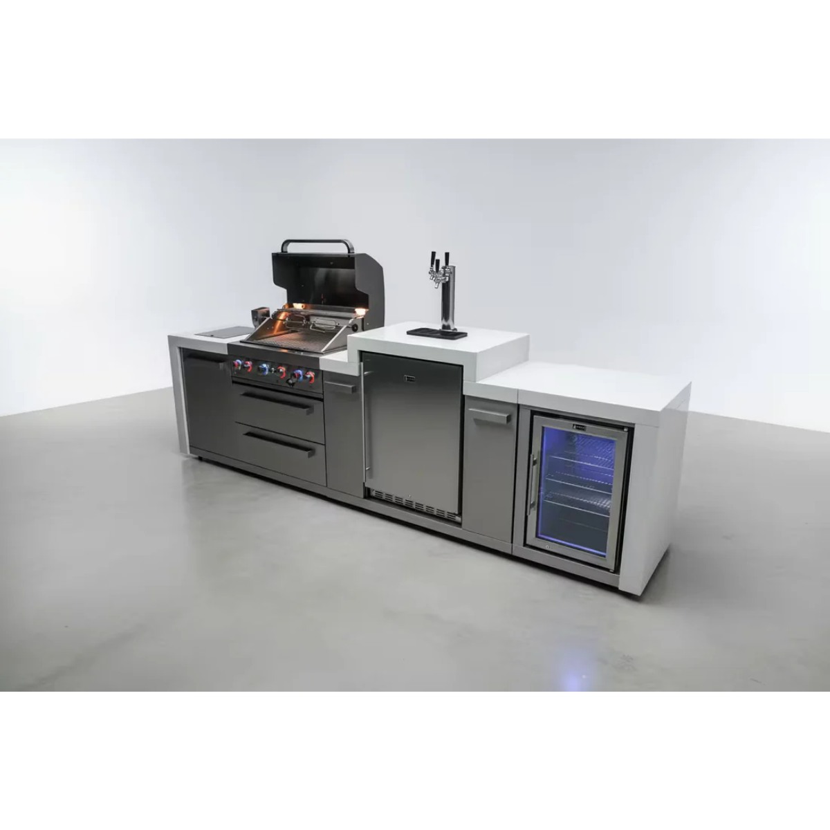 Studio view of the Mont Alpi 400 Deluxe Island featuring a built-in gas grill, kegerator with beer tap, fridge cabinet, storage drawers, and stainless steel outdoor kitchen design.