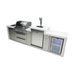 Angled front view of the Mont Alpi 400 Deluxe Island with closed grill hood, illuminated control knobs, integrated kegerator, fridge cabinet, and storage compartments.