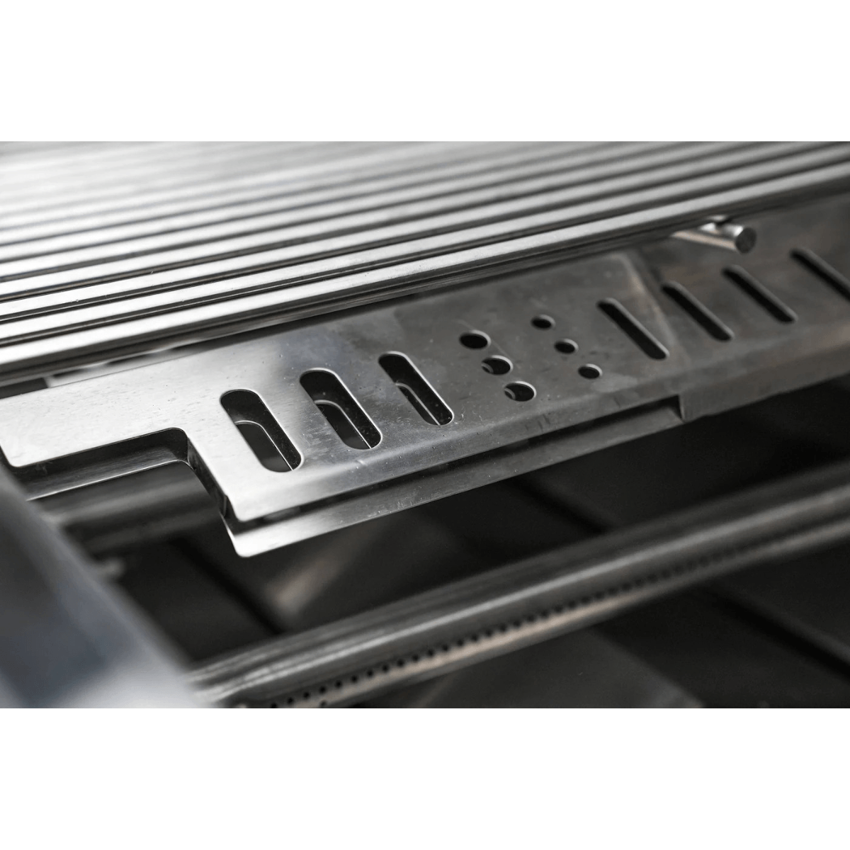 Detailed view of the Mont Alpi 44-Inch Built-In Grill interior, highlighting stainless steel flame tamers and heavy-duty cooking grates.