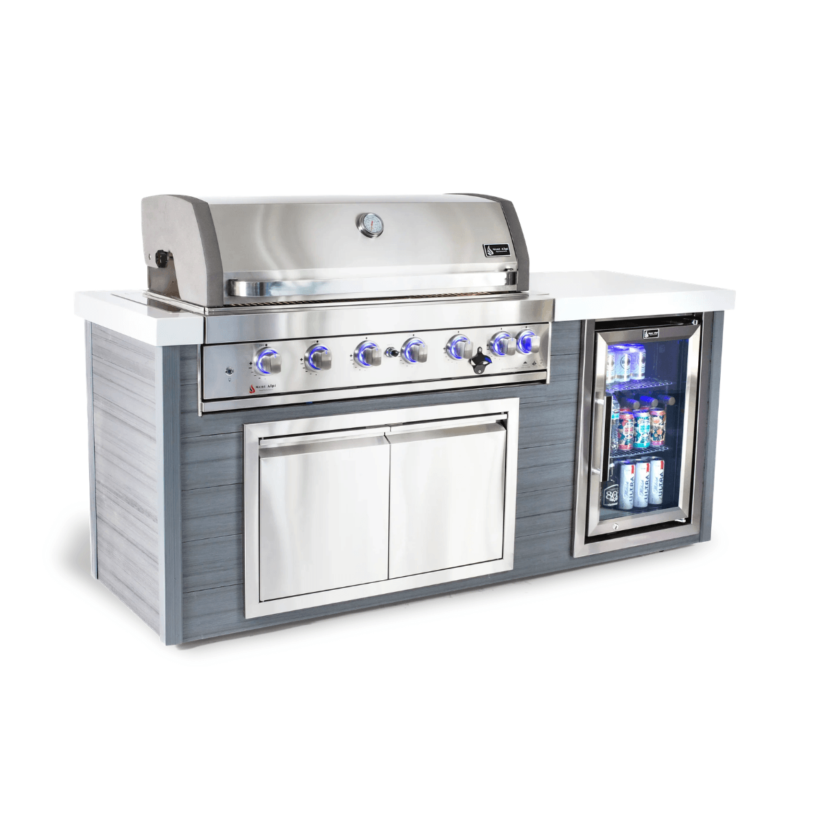 Angled front view of the Mont Alpi 6-Burner Stainless Steel Art-wood Outdoor Island Grill with stainless steel construction, blue LED control knobs, storage cabinet, and glass-front fridge.