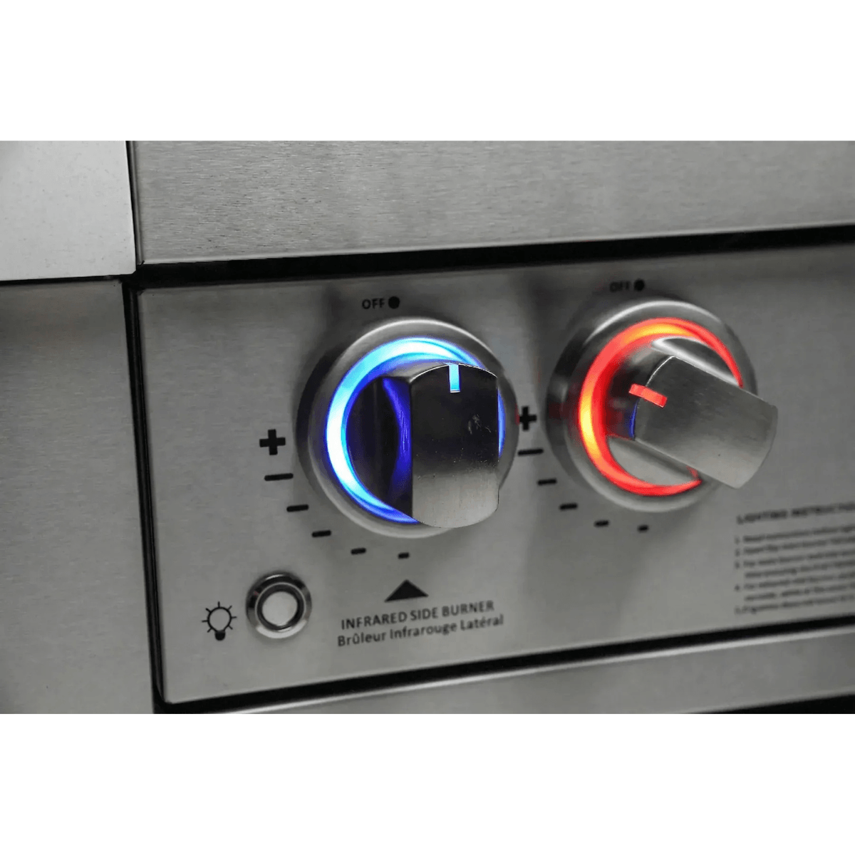 Close-up of illuminated Mont Alpi grill control knobs with blue and red LED lighting on the black stainless steel outdoor kitchen island.