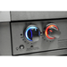 Close-up of illuminated Mont Alpi grill control knobs with blue and red LED lighting on the black stainless steel outdoor kitchen island.