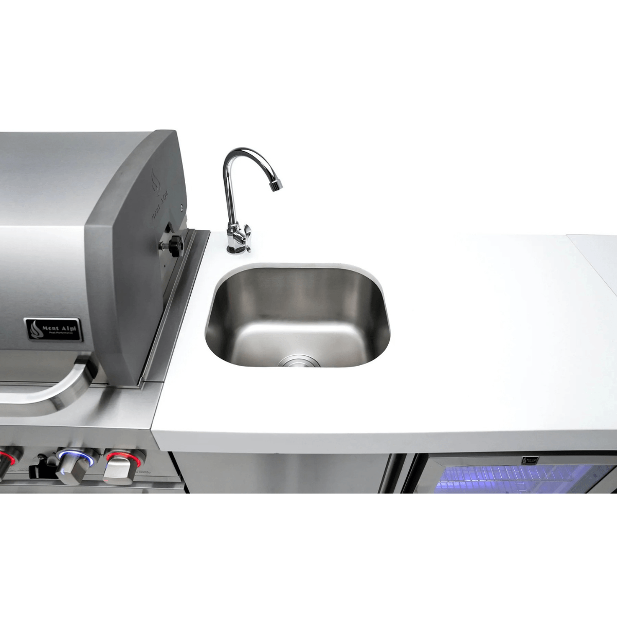 Integrated stainless steel sink and faucet on the Mont Alpi 805 Black Stainless Steel Island, featuring a spacious white countertop and built-in outdoor kitchen design.