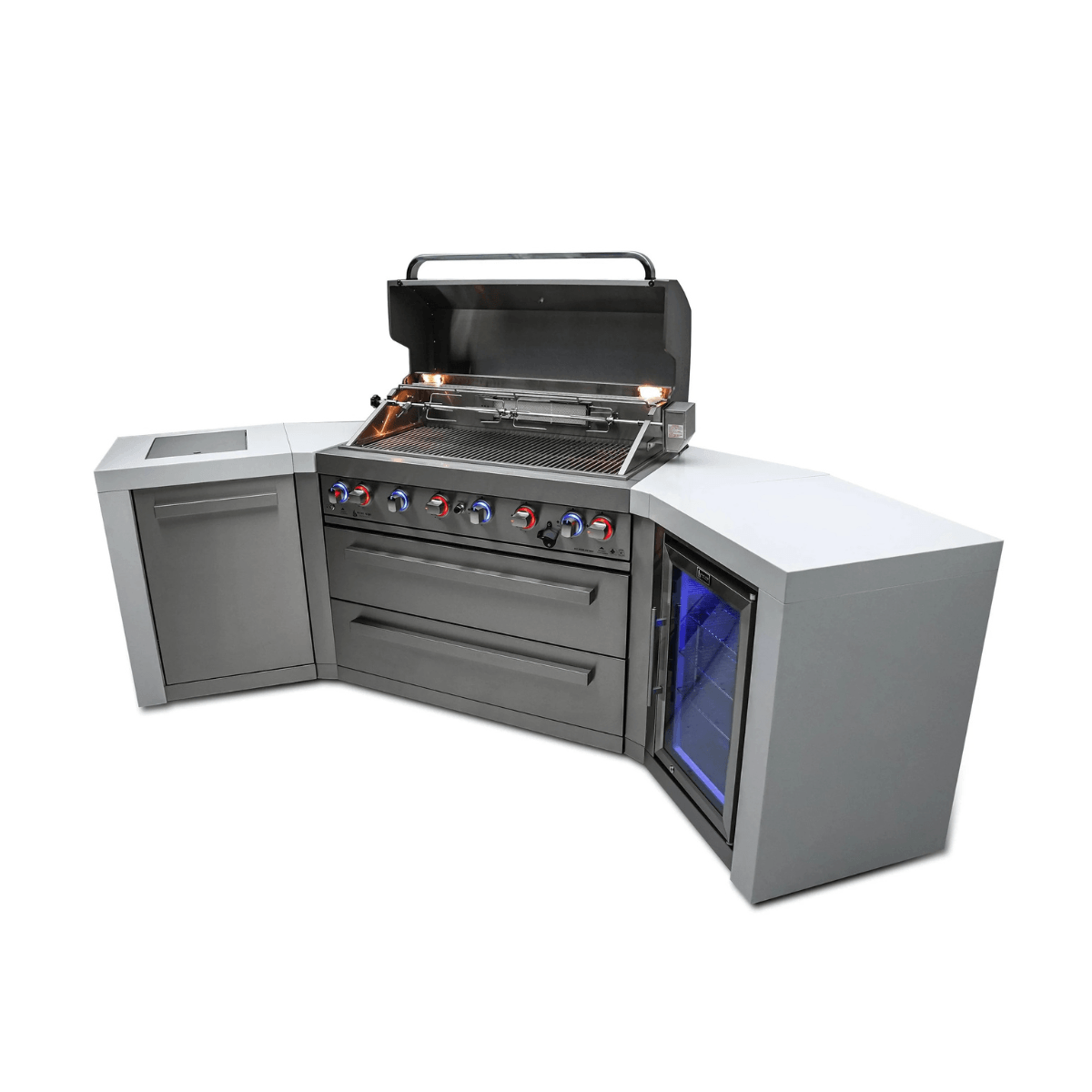 Angled view of the Mont Alpi 805 Deluxe Island with the grill hood open, showcasing the rotisserie-equipped cooking area, illuminated controls, storage drawers, and built-in refrigerator.