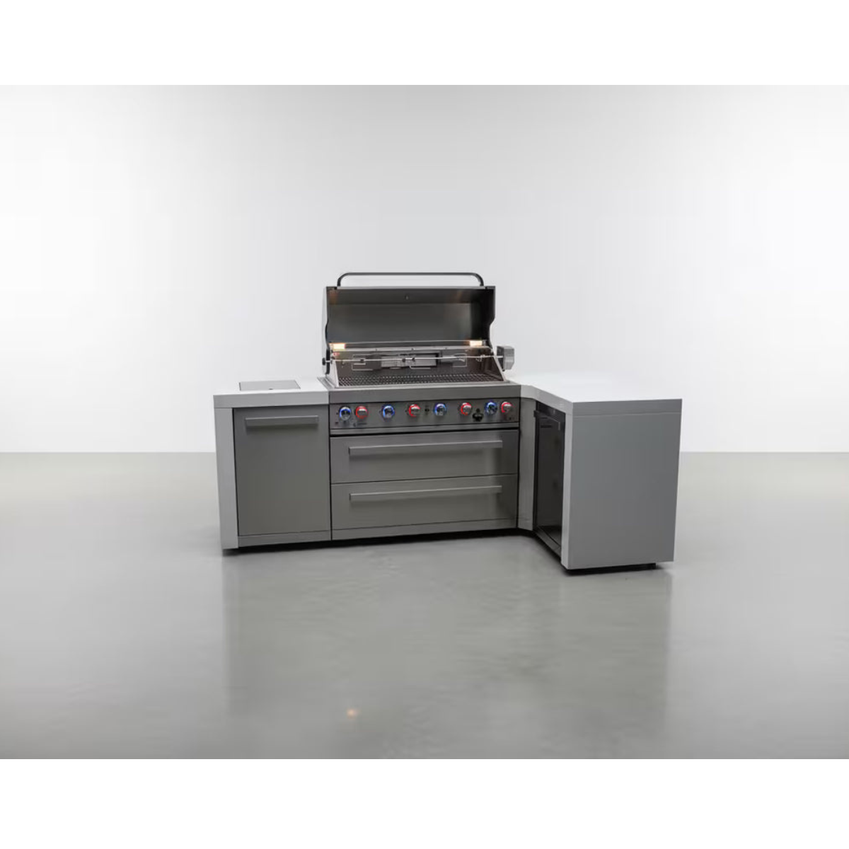Front view of the Mont Alpi 805 Deluxe Island with 90-degree corner, featuring an open stainless steel grill, storage cabinet, dual drawers, and integrated corner storage unit.