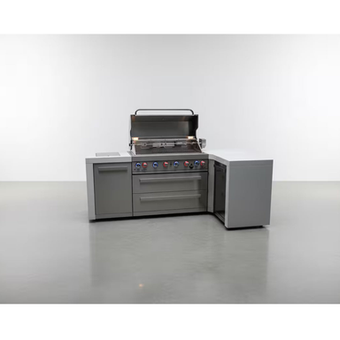 Front view of the Mont Alpi 805 Deluxe Island with 90-degree corner, featuring an open stainless steel grill, storage cabinet, dual drawers, and integrated corner storage unit.