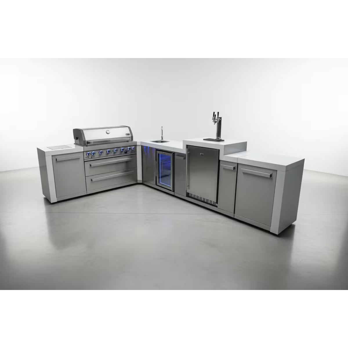 Studio display of the Mont Alpi 805 Deluxe Island featuring a gas grill, sink, kegerator, beverage center, and stainless steel cabinetry.