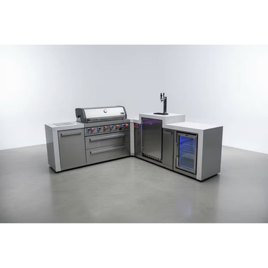 Studio display of the Mont Alpi 805 Deluxe Island with built-in grill, kegerator, storage cabinet, and illuminated fridge cabinet.