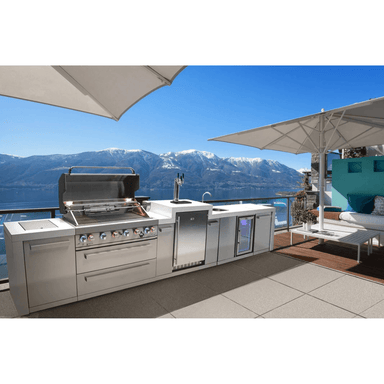 Mont Alpi 805 Deluxe Island with kegerator and beverage center installed on a luxury outdoor terrace overlooking a lake and mountain landscape.