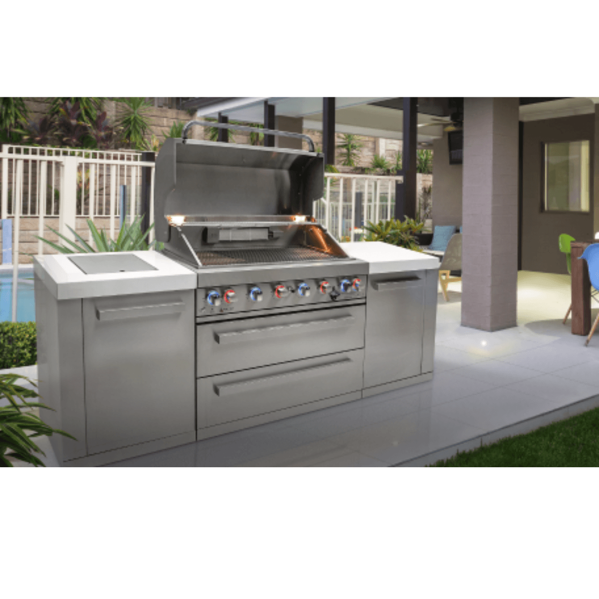Mont Alpi 805 Deluxe Island installed in a luxury outdoor patio setting with the grill hood open and integrated storage, kegerator, and fridge cabinet.