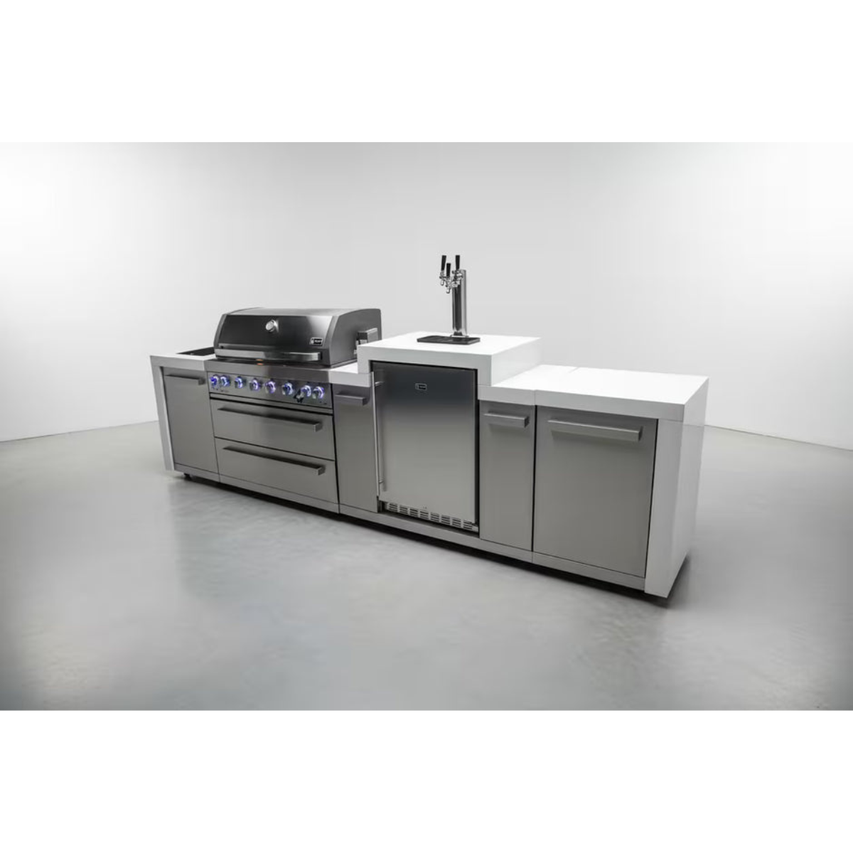 Mont Alpi 805 Deluxe Island with built-in grill, kegerator, storage cabinets, and white stone countertops in a studio setting.