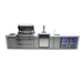 Front view of the Mont Alpi 805 Deluxe Island with the grill lid open, highlighting the cooking area, illuminated controls, kegerator, sink, and refrigeration units.