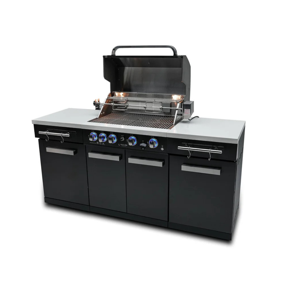 Front angled view of the Mont Alpi 957 Island with open grill hood, rotisserie kit, illuminated controls, and storage cabinets.