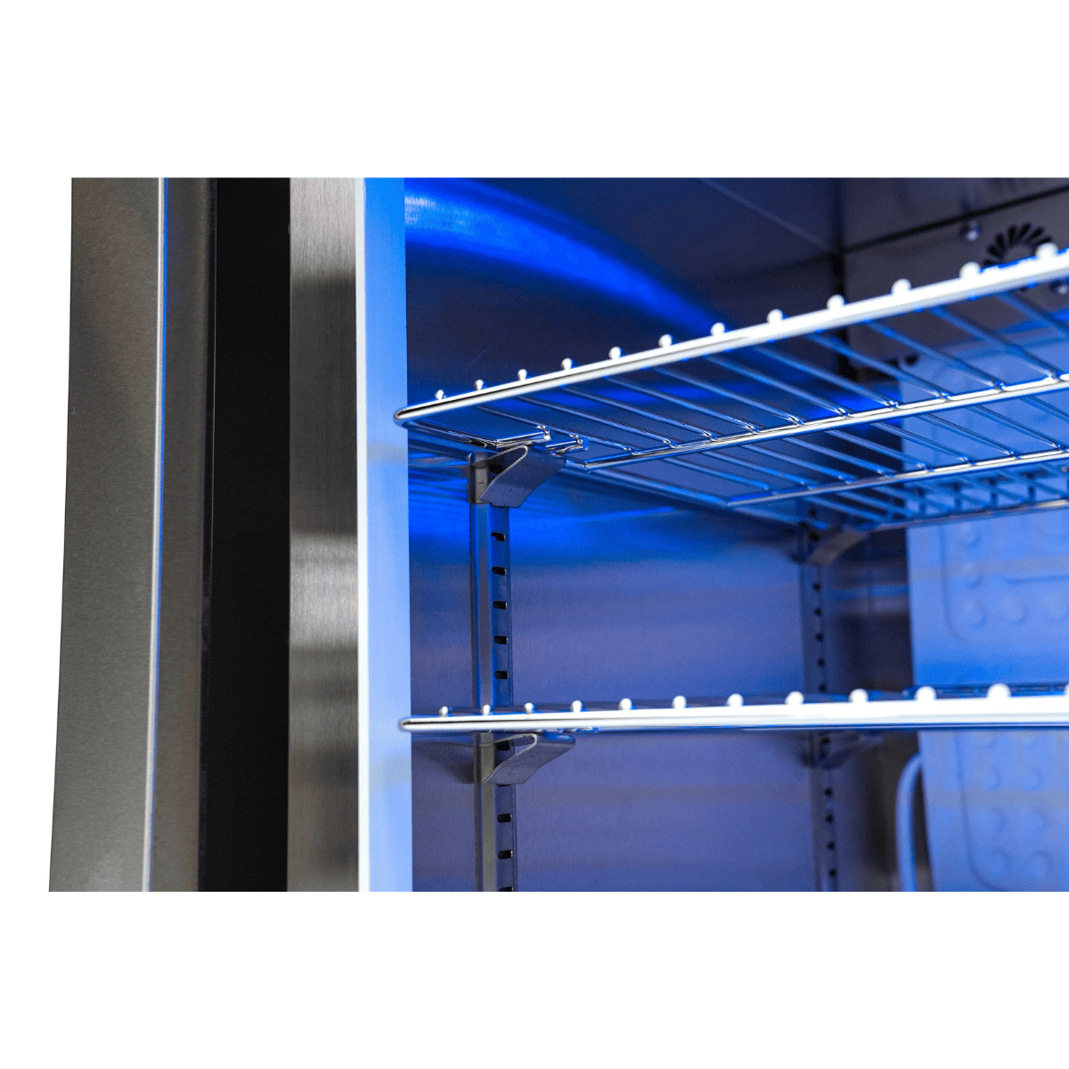 Close-up of the adjustable chrome wire shelves inside the Mont Alpi fridge cabinet with illuminated interior.