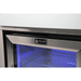 Mont Alpi logo displayed on the black stainless steel fridge cabinet door with blue LED interior lighting visible through the glass.