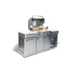 Angled view of the Mont Alpi Compact Island with Refrigerator featuring an open grill lid, rotisserie system, interior lighting, and built-in beverage cooler.