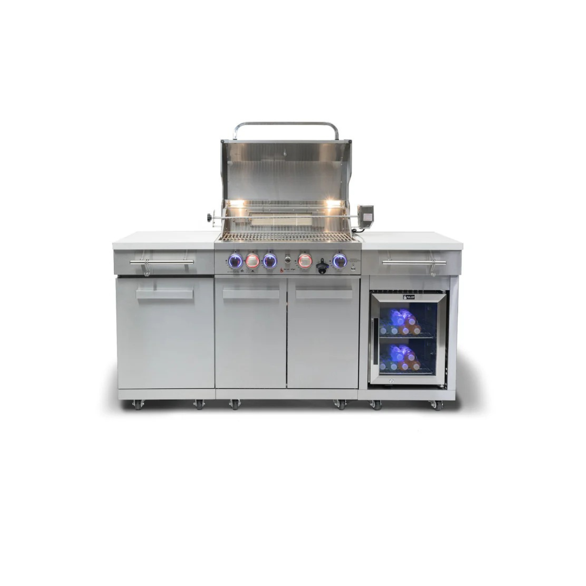 Front view of the Mont Alpi Compact Island with Refrigerator with the grill lid open, revealing stainless steel cooking grates, warming rack, and illuminated controls.