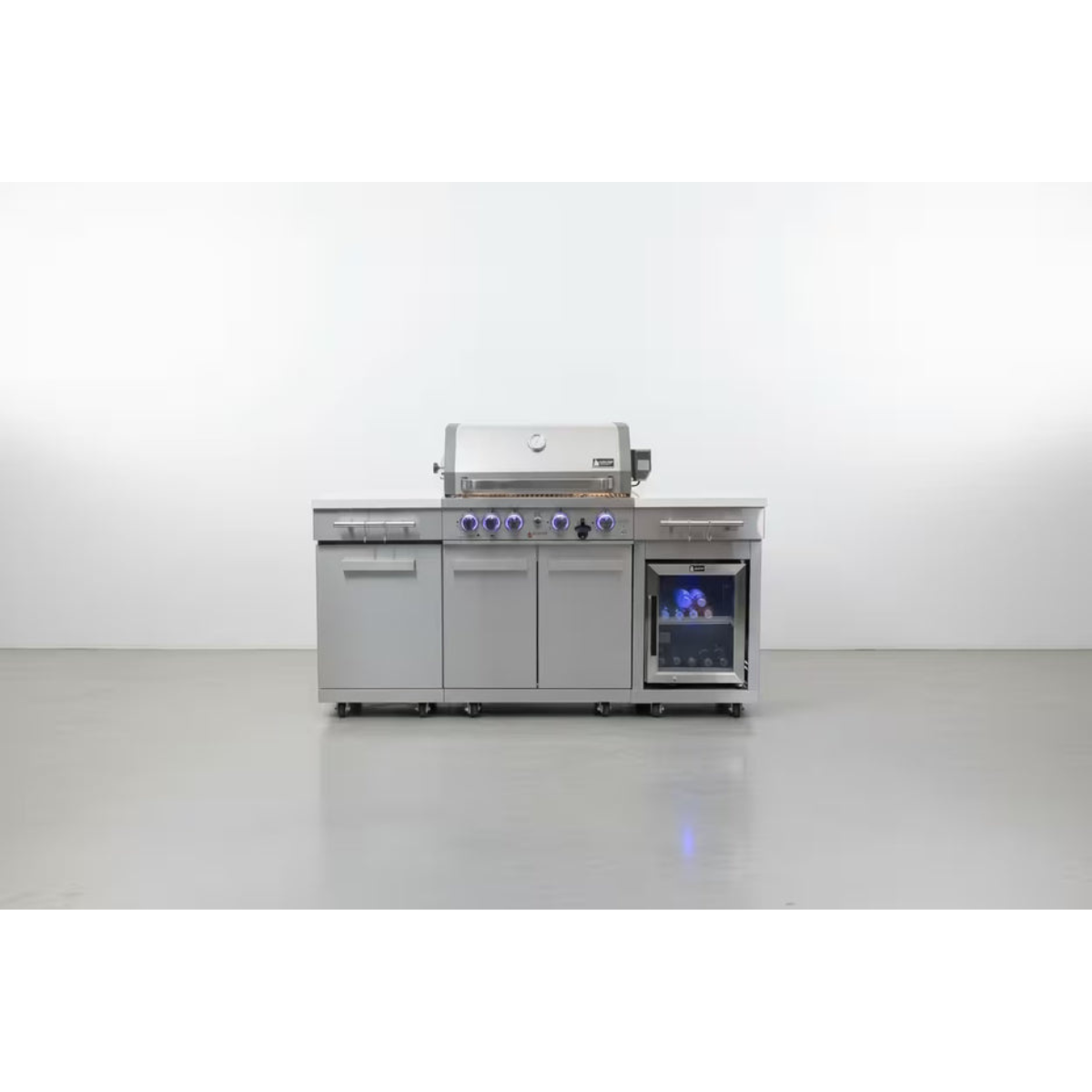 Wide front view of the Mont Alpi Compact Island with Refrigerator showing the complete outdoor kitchen setup with storage cabinets and illuminated fridge.