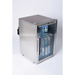 Angled view of the Mont Alpi outdoor refrigerator featuring a stainless steel cabinet, glass door, blue interior lighting, and stocked beverage shelves.