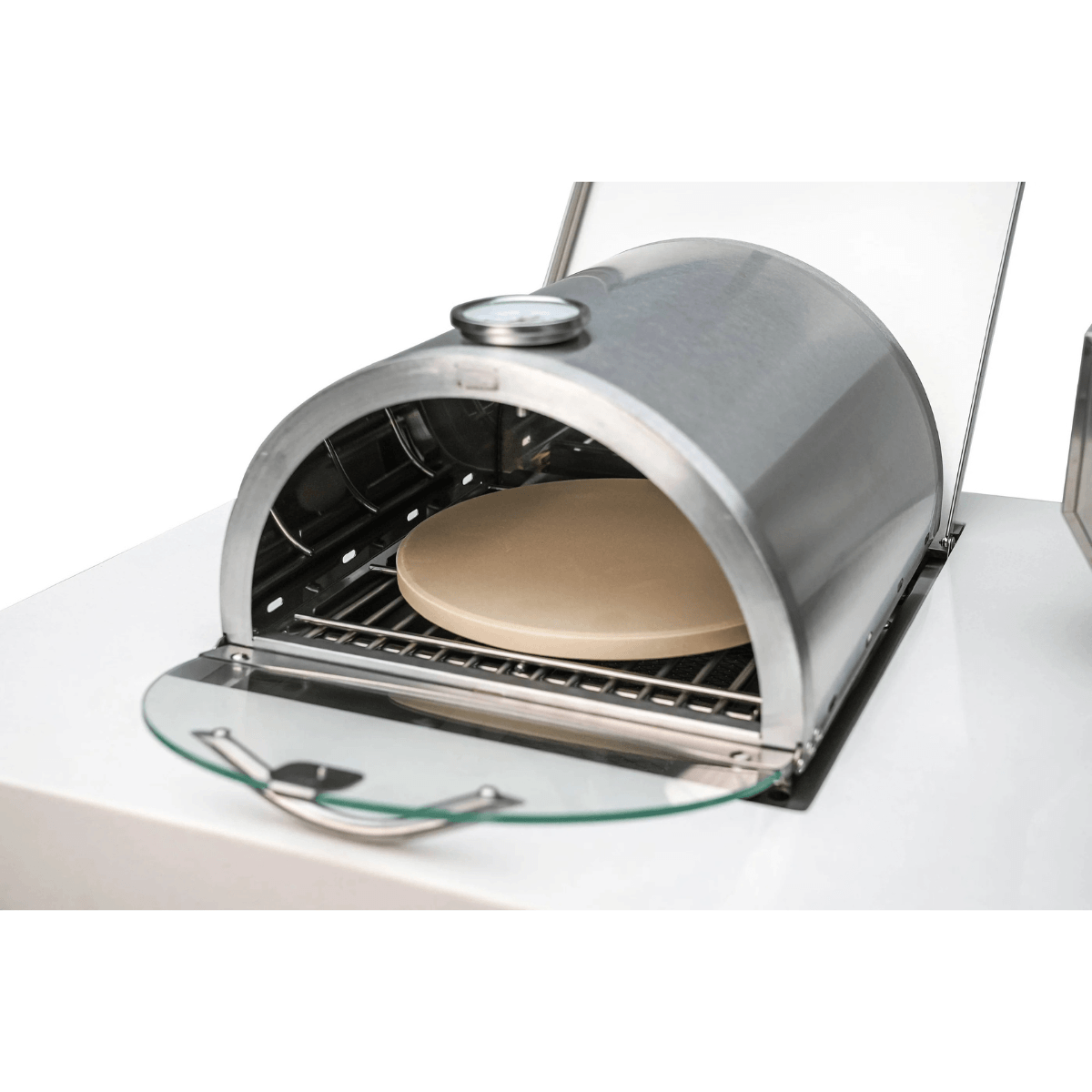 Open-door view of the Mont Alpi universal side burner pizza oven revealing the ceramic pizza stone and stainless steel cooking chamber.