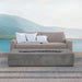Pyromania Alchemy fire table styled in an outdoor lounge area beside a modern sofa and pool.