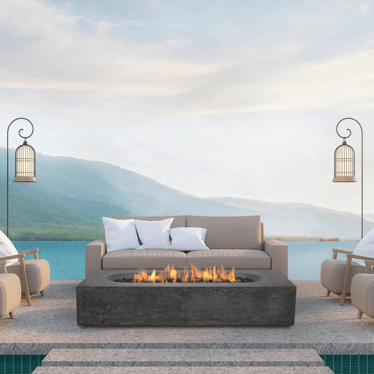 Dark grey Pyromania Alchemy fire table with active flames in a luxury outdoor seating setup.