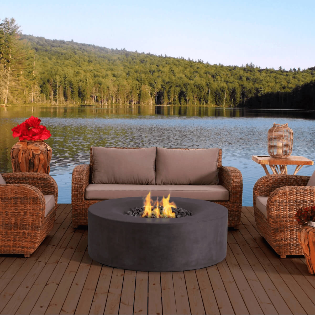 Avalon concrete fire pit with wicker patio furniture beside a lakeside outdoor setting.