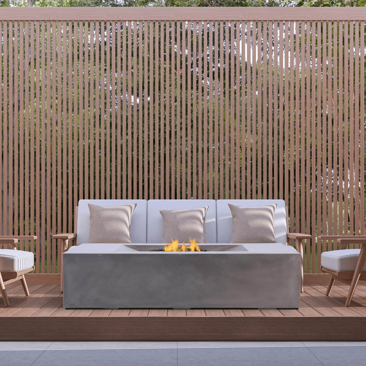 Pyromania Moderne fire table with outdoor lounge seating and wood privacy screen backdrop.