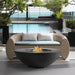 Dark grey Pyromania Shangri-La fire table with flames beside a luxury poolside seating area.
