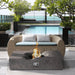 Pyromania Venice concrete fire table with modern curved centre design in outdoor poolside setting.