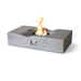 Light grey Pyromania Venice fire table with curved top design and active fire display.