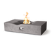 Angled view of the Pyromania Venice concrete fire table with curved recessed burner and flames.